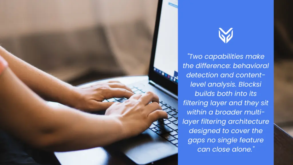 The image shows a person typing on their laptop. 